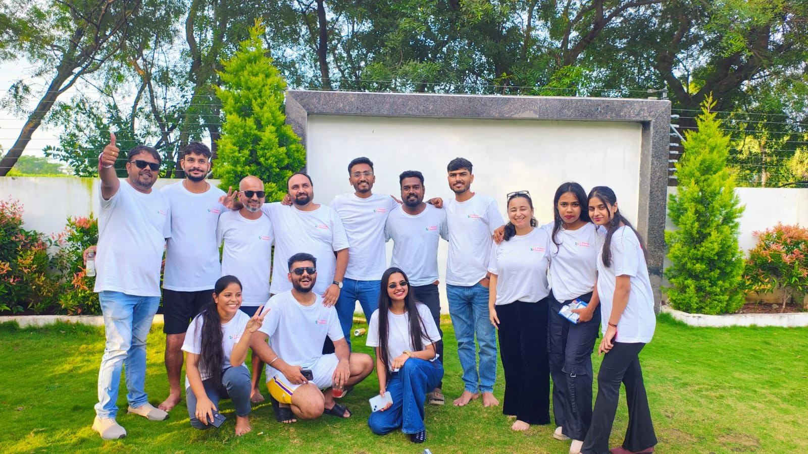 C Prompt colleagues in white shirts gathered outdoors.